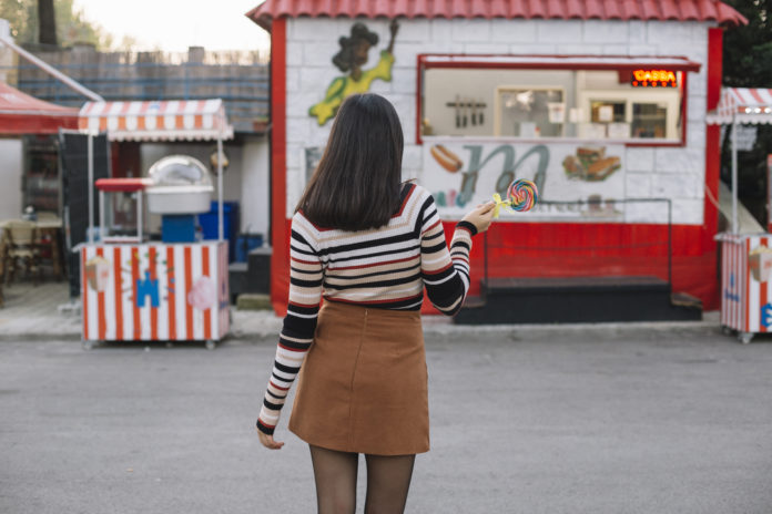 A colorful food cart business with delicious street food displayed.